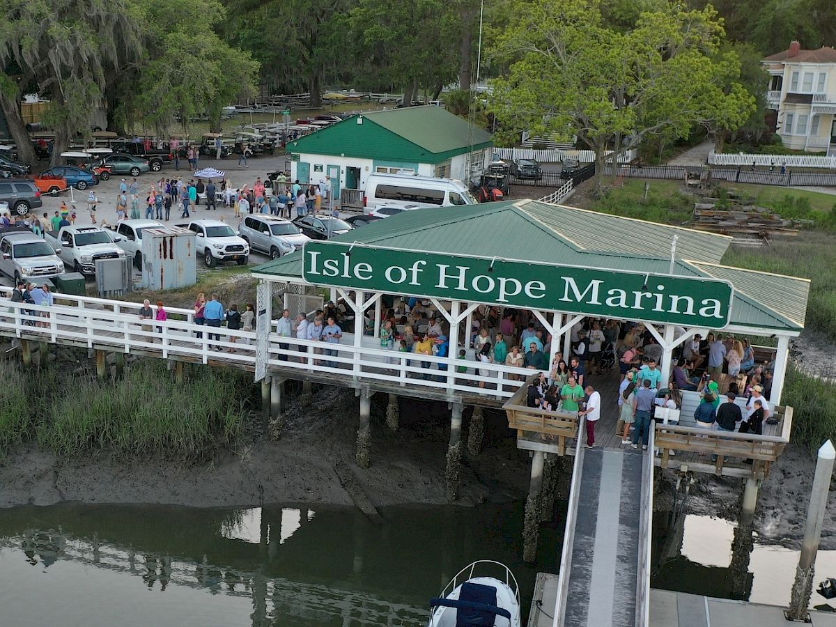 A busy marina with a green roof sign reads 