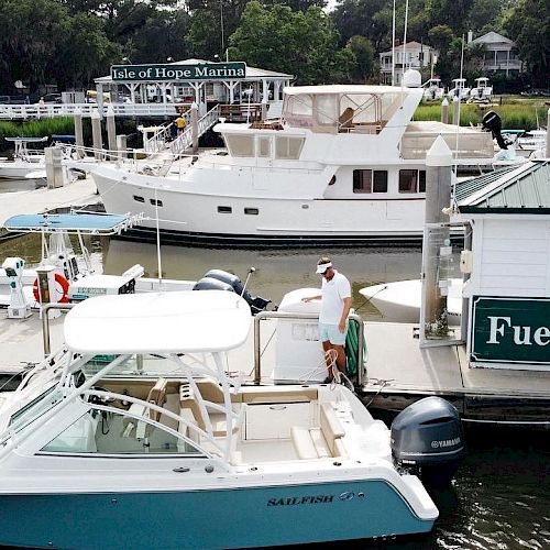 Boats docked at a marina with a fuel station labeled 